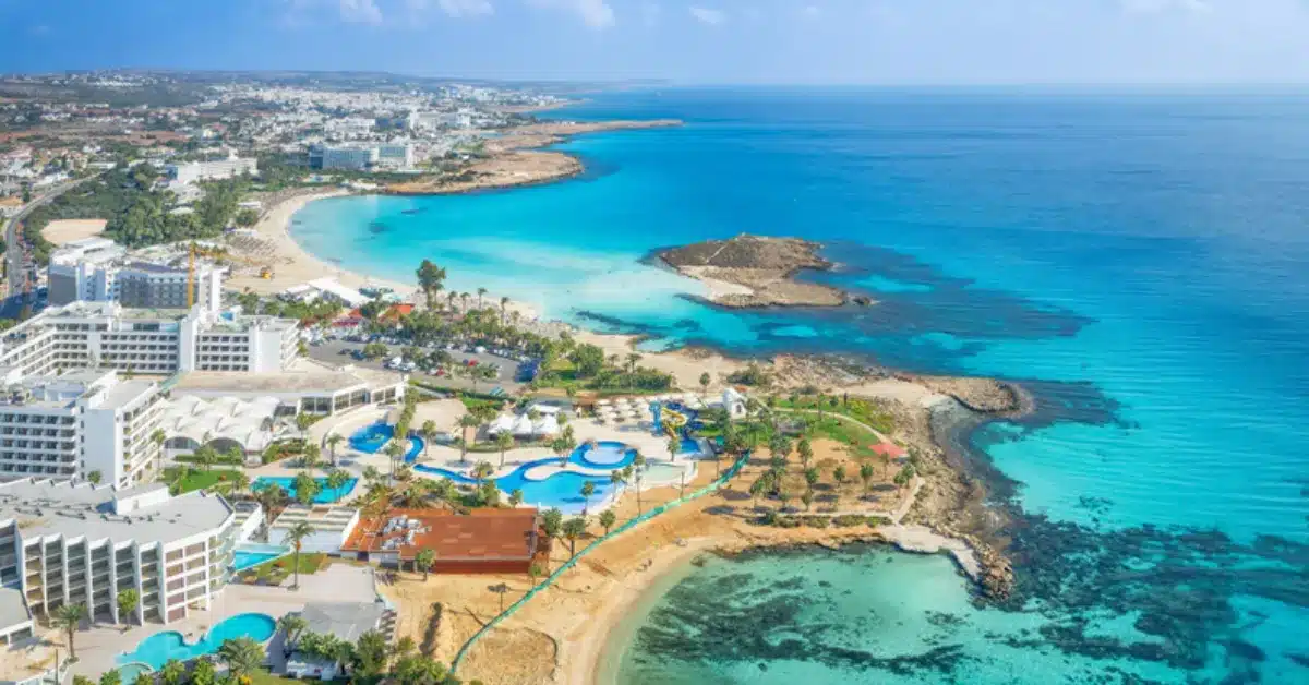 n aerial shot of the stunning Ayia Napa coastline and resorts in Southern Cyprus, a popular area for non-residents looking to secure an overseas mortgage.