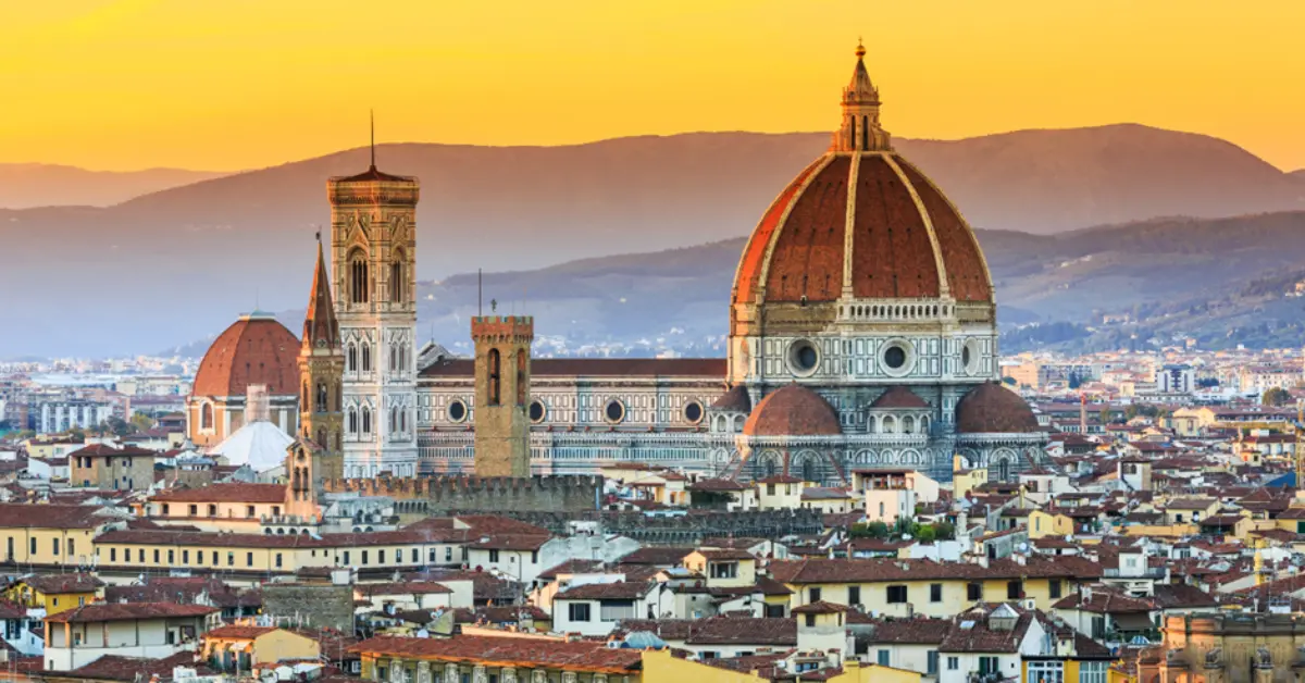 A panoramic view of the Florence skyline at sunset, featuring the Duomo, representing the strong real estate market and property prices in Tuscany, Italy.