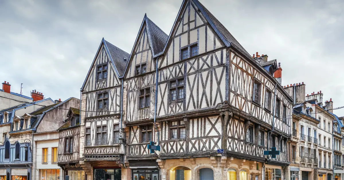 A historic building with traditional half-timbered architecture, a classic style to consider when buying property in france.