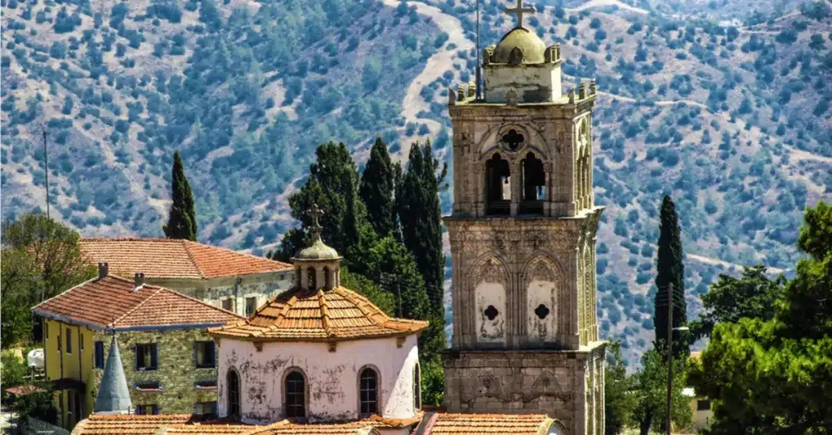 A historic stone church in a Southern Cyprus village, representing the rich culture and legal process of securing property title deeds for non-resident buyers.